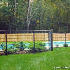 Vinyl Chain Link Fence by Sudbury Cedar Fence Co surrounds a swimming pool in Sudbury, MA