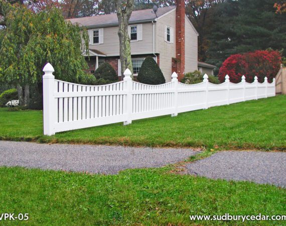 Classic white vinyl picket fence installed along landscaped residential front yard in Framingham, Massachusetts.