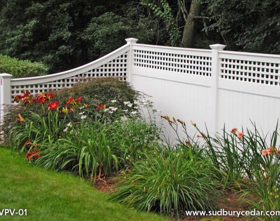 White vinyl privacy fence with lattice top and lush landscaping by Sudbury Cedar Fence Co., in Hudson, MA.