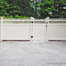 Vinyl board fence with decorative top by Sudbury Cedar Fence Co