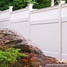 White vinyl board fence with decorative topper