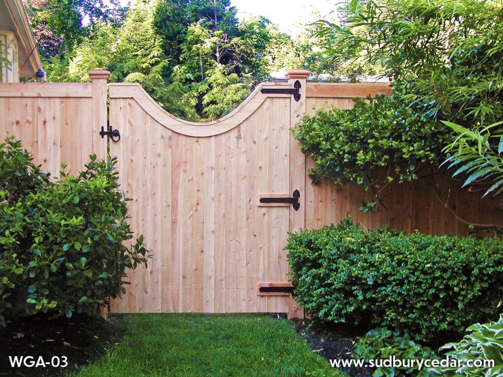 Cedar gate with a graceful curve finished with black hardware.