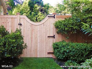 Cedar gate with a graceful curve finished with black hardware.