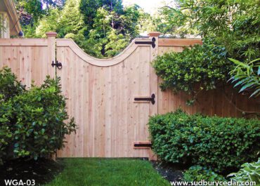 Cedar gate with a graceful curve finished with black hardware.