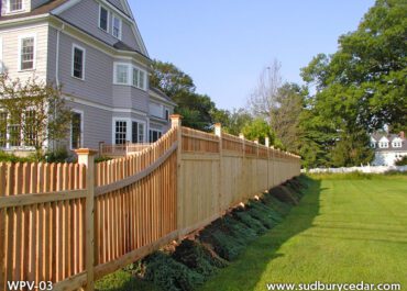 Cedar privacy fence with picket top detail along residential property in Concord, MA.