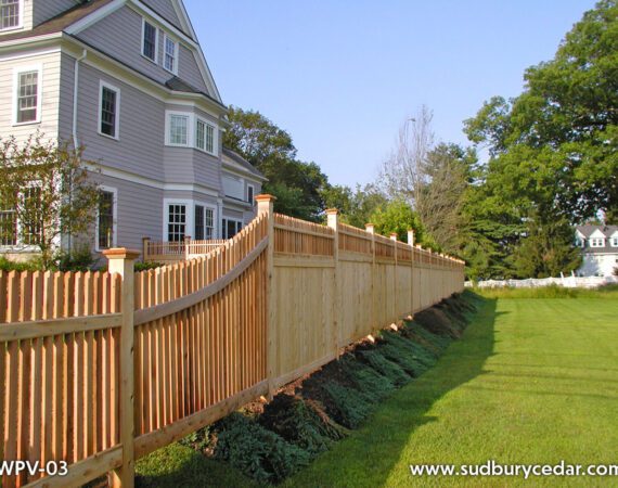 Cedar privacy fence with picket top detail along residential property in Concord, MA.