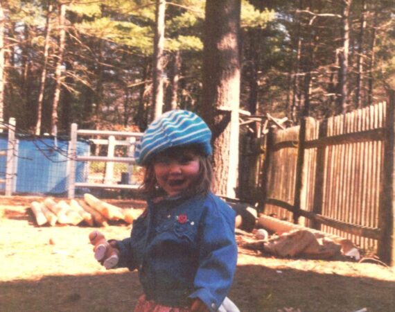 Young child in front of fence material and installed fence.