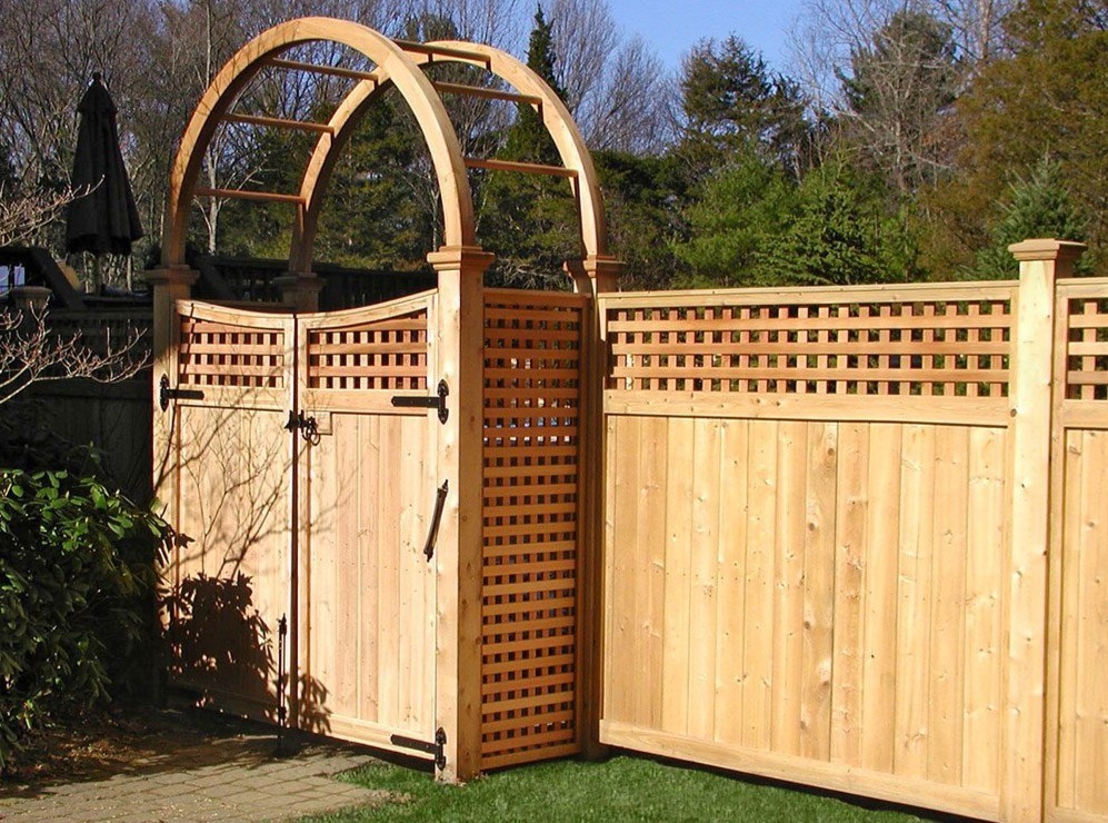 Custom cedar fence gate with arched arbor designed to enhance curb appeal. Sudbury Cedar Fence Co.