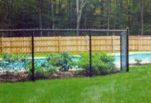 Chain link and Cedar fence installation surrounding pool by Sudbury Cedar Fence Co in Hudson, MA