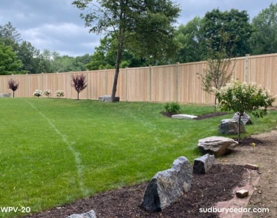 Cedar privacy fence enclosing backyard in Bolton MA with landscaped lawn and trees