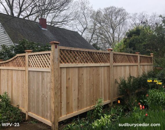 Cedar privacy fence with lattice top and wood posts in landscaped yard in Stow, MA.