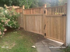 Cedar privacy fence with custom wood gate and black hardware in Acton, MA