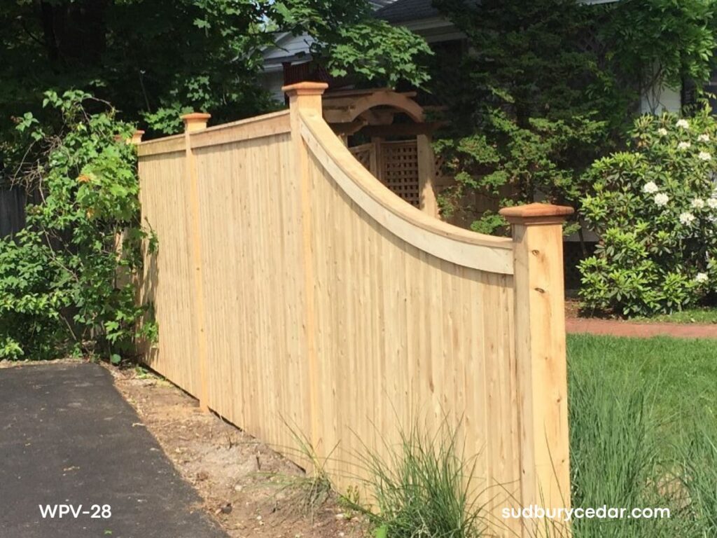 Curved top cedar privacy fence with custom shape and natural wood finish in Concord, MA.