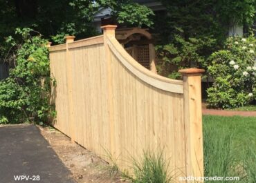 Curved top cedar privacy fence with custom shape and natural wood finish in Concord, MA.