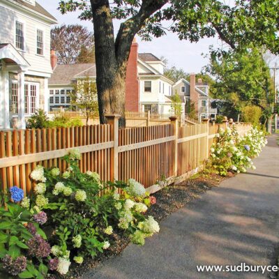 cedar picket fence installed along landscaped front yard in metrowest massachusetts