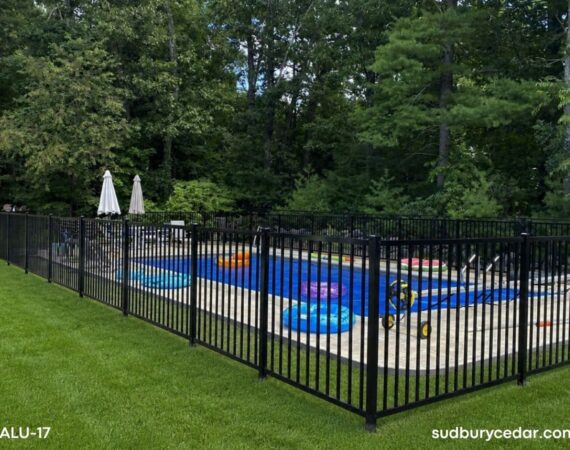 Black ornamental aluminum fence enclosing a residential swimming pool with open sightlines and decorative finial accents