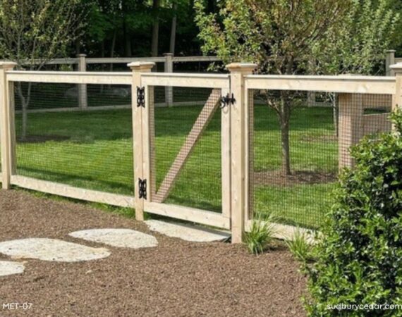 Cedar post and wire fence with matching gate enclosing a landscaped backyard in Concord, Massachusetts