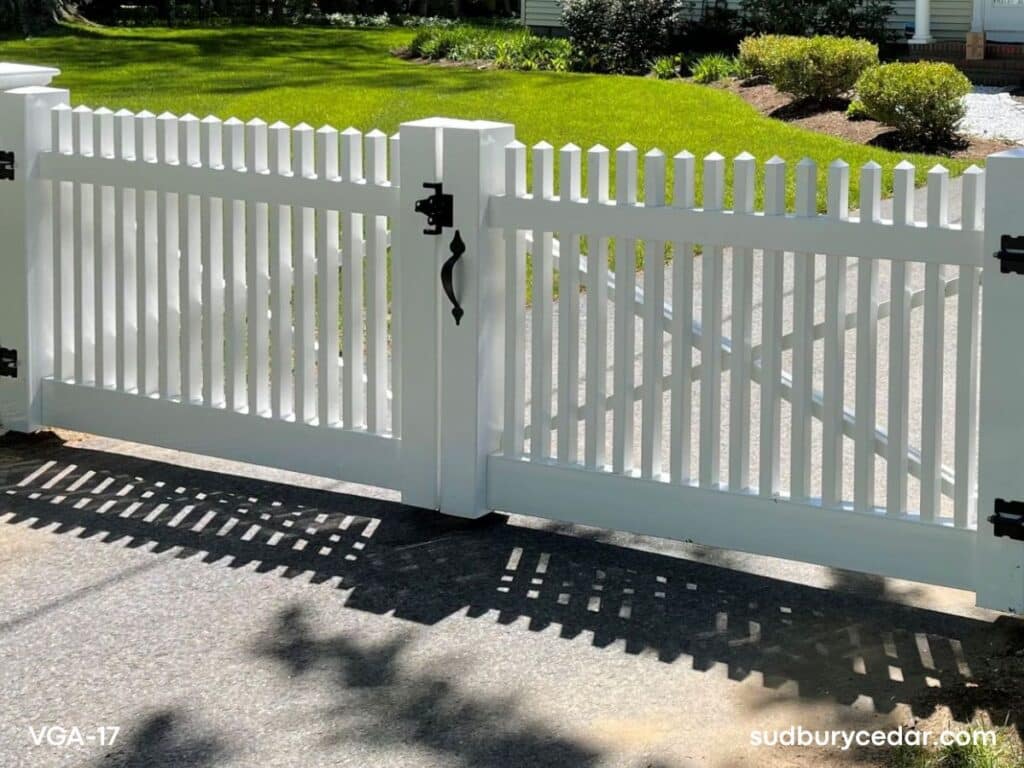 Custom white vinyl driveway gate with black hardware installed in Concord Massachusetts