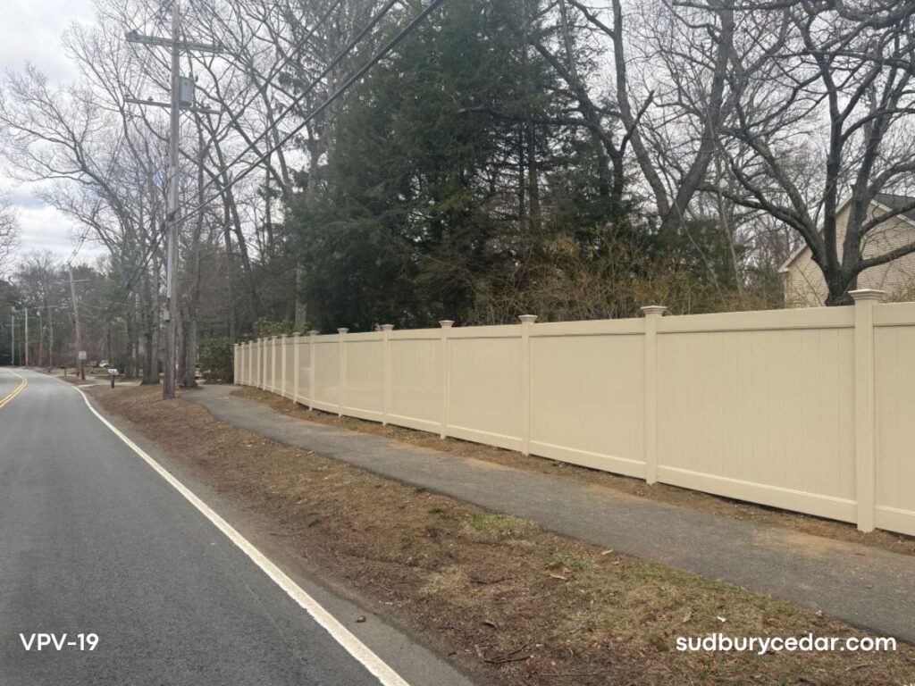 Almond vinyl privacy fence along roadway in Sudbury, Massachusetts