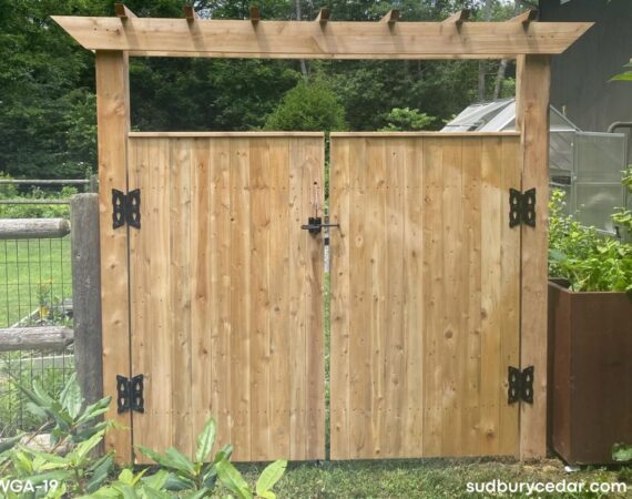 Custom cedar garden gate with pergola-style arbor and black decorative hardware installed in MetroWest Massachusetts