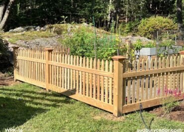cedar picket garden enclosure installed in landscaped backyard in weston massachusetts