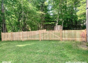 cedar picket fence installed along wooded backyard property in hudson massachusetts