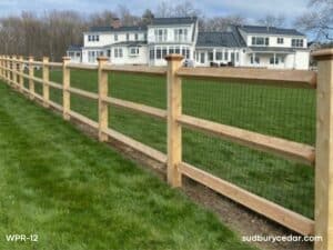 cedar post and rail fence with wire mesh surrounding large residential property in harvard ma