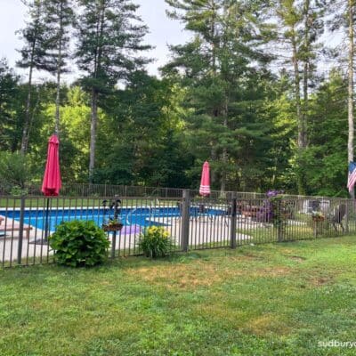 Bronze aluminum fence around pool in Hudson, MA.