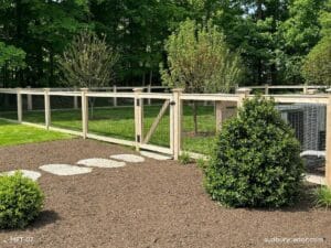 Cedar post and wire fence with matching gate enclosing a landscaped backyard in Concord, Massachusetts