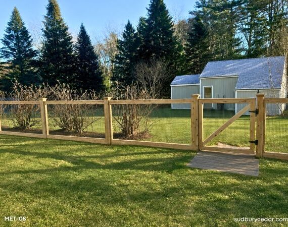 Cedar postband wire fence enclosing backyard in Boxborough, MA.
