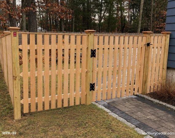 Spaced cedar board fence with matching gate in MetroWest, MA.