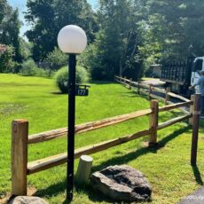 Rustic split rail fence defines property borders in Boxborough, MA .