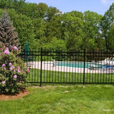 Black aluminum 3 rail fence surrounds pool in MetroWest MA.