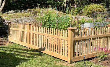 cedar picket garden enclosure installed in landscaped backyard in weston massachusetts